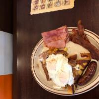 Hungry Man French Toast · Served with ham, bacon, sausage and 2 eggs any style.