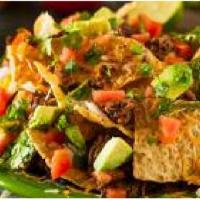 Nachos Grande · Crispy tortilla chips piled high with diced char-grilled chicken, shredded lettuce, diced to...