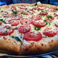 Margherita Pizza · Fresh basil, roasted roma tomatoes & feta cheese atop an olive oil & garlic base.