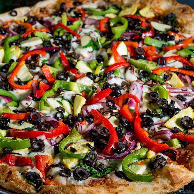 Extreme Veggie Pizza · Roasted red & green peppers, fresh mushrooms, spinach, onions, zucchini, black olives & chopped garlic.