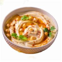 Hummus  · Ground chickpeas blended with oil,lemon juice,garlic,tahini,black pepper,cumin and salt.