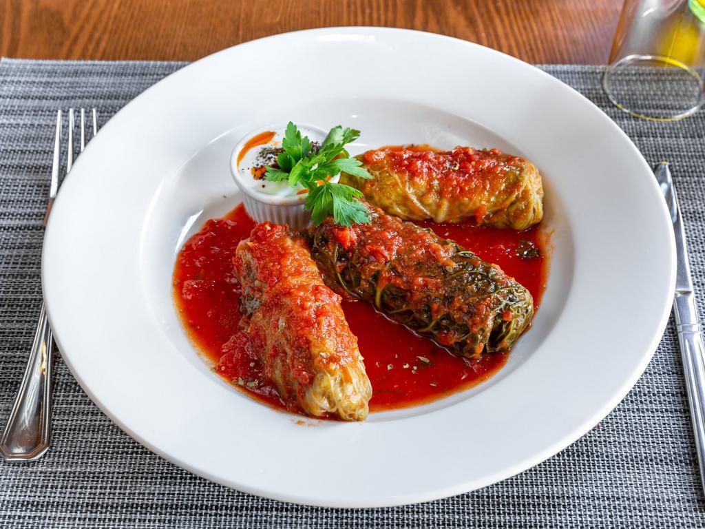 Stuffed cabbage leaves · cabbage with rice and ground lamb served with garlic yogurt.