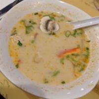 16. Tom Kha Gai · Spicy chicken soup. Spicy Thai coconut milk soup with chicken, mushroom, cilantro, lime juic...