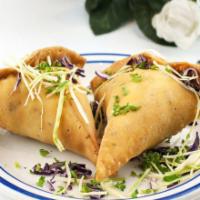 Samosas · Crispy pastry filled with mashed potatoes and green peas.