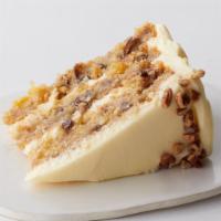 Hummingbird Cake Slice to go · Bananas, pineapples and pecans make up this classic southern cake with sweetened cream chees...