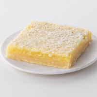 Lemon Bar to go · Shortbread cookie crust with a tart lemon filling, covered with powdered sugar.