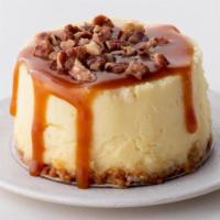Caramel Pecan Cheesecake to go · Rich vanilla bean cheesecake topped with caramel and toasted pecans, finished with a graham ...