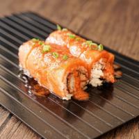 Fire Dragon Roll · Shrimp tempura and avocado topped with salmon and spicy special sauce.