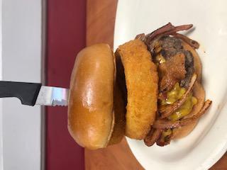1/2 Pound Classic Steak Bacon Onion Burger · Fresh steak burger cooked to your choice of doneness served with bacon, fried onion rings, slice of cheddar cheese and topped with fried onions with A1 sauce and maple syrup. Served on a toasted bun