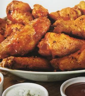Jumbo Wings · Jumbo naked wings deep fried to perfection then tossed in your sauce or rub of choice.  Served with your choice of Ranch or Bleu Cheese Dressing and Celery Sticks.