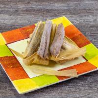 Sweet Tamale Dozen · The sweet tamales are made with coconut, raisins, and pecans. They are enjoyed especially fo...