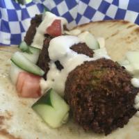 Falafel · Deep-fried falafel balls topped with our famous Israeli salad and tahini on grilled pita