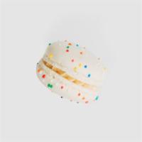 Birthday Cake Macaron · Funfetti sprinkled vanilla shell filled with birthday cake buttercream.