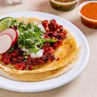 Chorizo Taco · Topped with onions and cilantro, lime wedge, radish. Choice of sauce.
