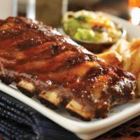 Slow Roasted Baby Back Ribs · Dry-rubbed, slow-roasted baby back pork ribs, brushed with a sweet and tangy BBQ sauce. Serv...
