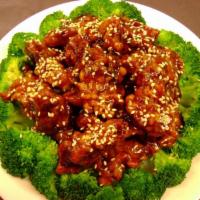 Sesame Chicken · Chicken battered and deep fried in a sweet sesame sauce served with steamed broccoli, an egg...
