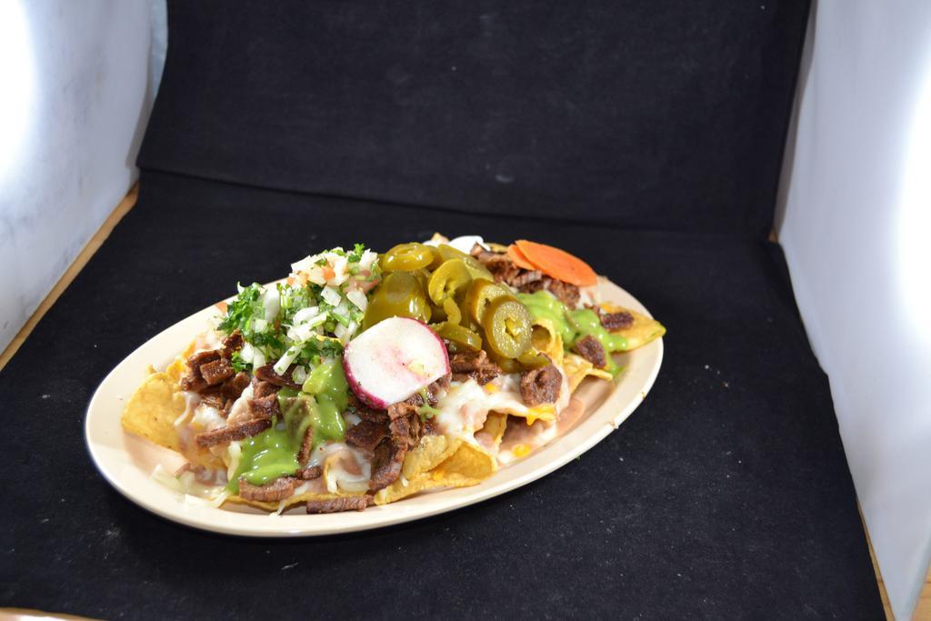 6. Nachos Suprime · Tortilla chips, meat of your choice, Pico de Gallo, sour cream, and guacamole sauce