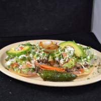 11. Tostadas · Hard tortillas topped with veggies, beans, meat of your choice, sour cream, and guacamole sa...