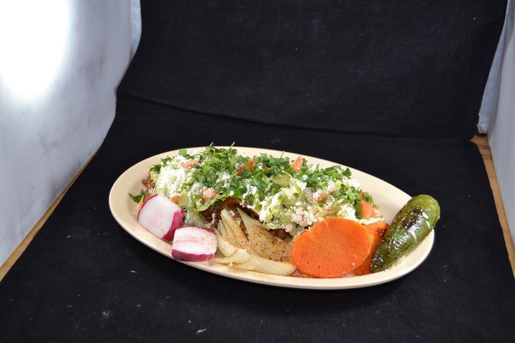 13. Huarache · Corn masa topped with meat, veggies, Mexican cheese, sour cream, beans, and guacamole