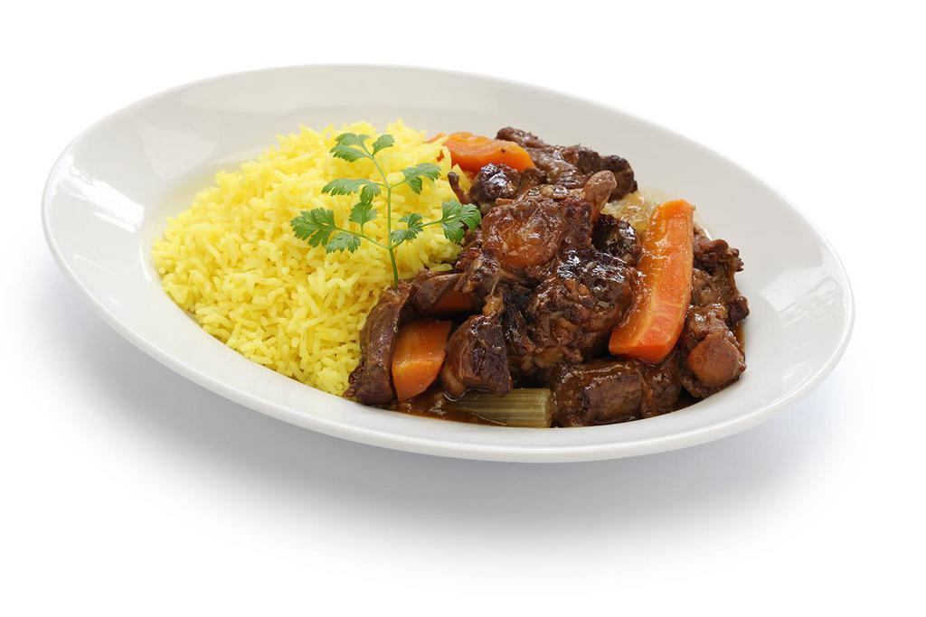 Stew Oxtail · Rabo guisado. Served with yellow or white rice, stew beans, fried green plantain or sweet plantains.