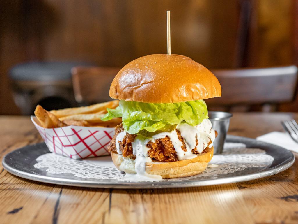 Buttermilk Crispy Chicken Sandwich  · Served with little gem lettuce, sweet-hot pickles, dill dressing  served with fries.