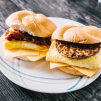 Sausage, Egg and Cheese on Roll · Finely chopped or ground meat, often mixed with seasoning. Sandwich served on a soft bread r...
