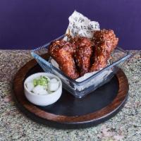 Dak Nal Ke Tikim · Spicy honey chili glazed crispy chicken wings with pickled daikon.