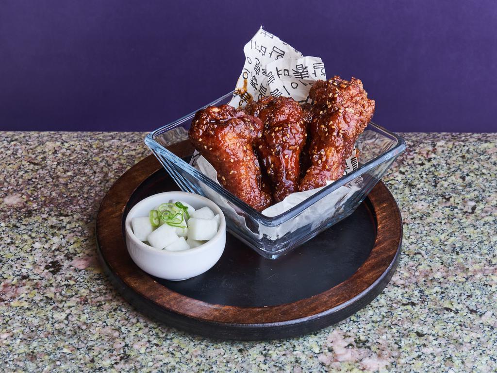 Dak Nal Ke Tikim · Spicy honey chili glazed crispy chicken wings with pickled daikon.