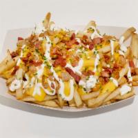 King Fries · Great fries topped with cheese sauce, chopped bacon, sour cream and chives. Cooked for appro...