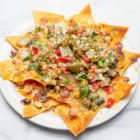  Nachos · A plate of homemade tortilla chips, topped with beans, monterey cheese, pico de gallo, jalap...