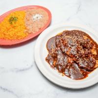Pollo con Mole · Grilled chicken breast simmered in mole sauce served with rice, refried pinto beans and corn...