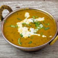 Daal Makhani · Black lentils cooked overnight on a slow fire with herbs.