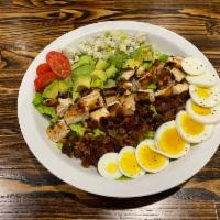 Cobb Salad · Romaine lettuce topped with egg, bacon, blue cheese, avocado, diced chicken, and grape tomat...