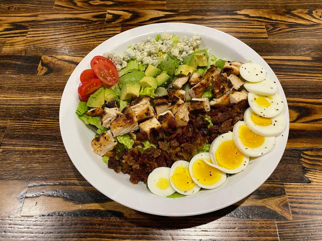 Cobb Salad · Romaine lettuce topped with egg, bacon, blue cheese, avocado, diced chicken, and grape tomatoes. Choice of dressing.
