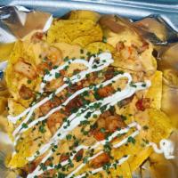 Seafood nachos · Crispy tortilla chips with melted cheese, sour cream, shrimp crawfish, chives