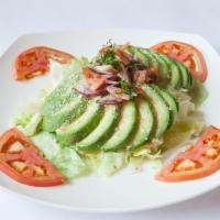 Ensalada de Aguacate · Lettuce and avocado topped with citrus onions and tomatoes.  