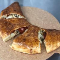 Calzone · Start with our scratch made dough add Ricotta cheese  then stuffed with whole-milk mozzarell...