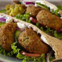 Large Falafel Wrap · Includes lettuce, tomatoes, and onions with your choice of sauce and wrap. Add toppings for ...