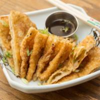 Scallion Pancakes  · House-made scallion dough fried crispy; served with a spicy, black vinegar dipping sauce