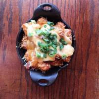 Tater Tots · Garlic Sriracha Cheese, scallions and bacon on top of crispy tots
