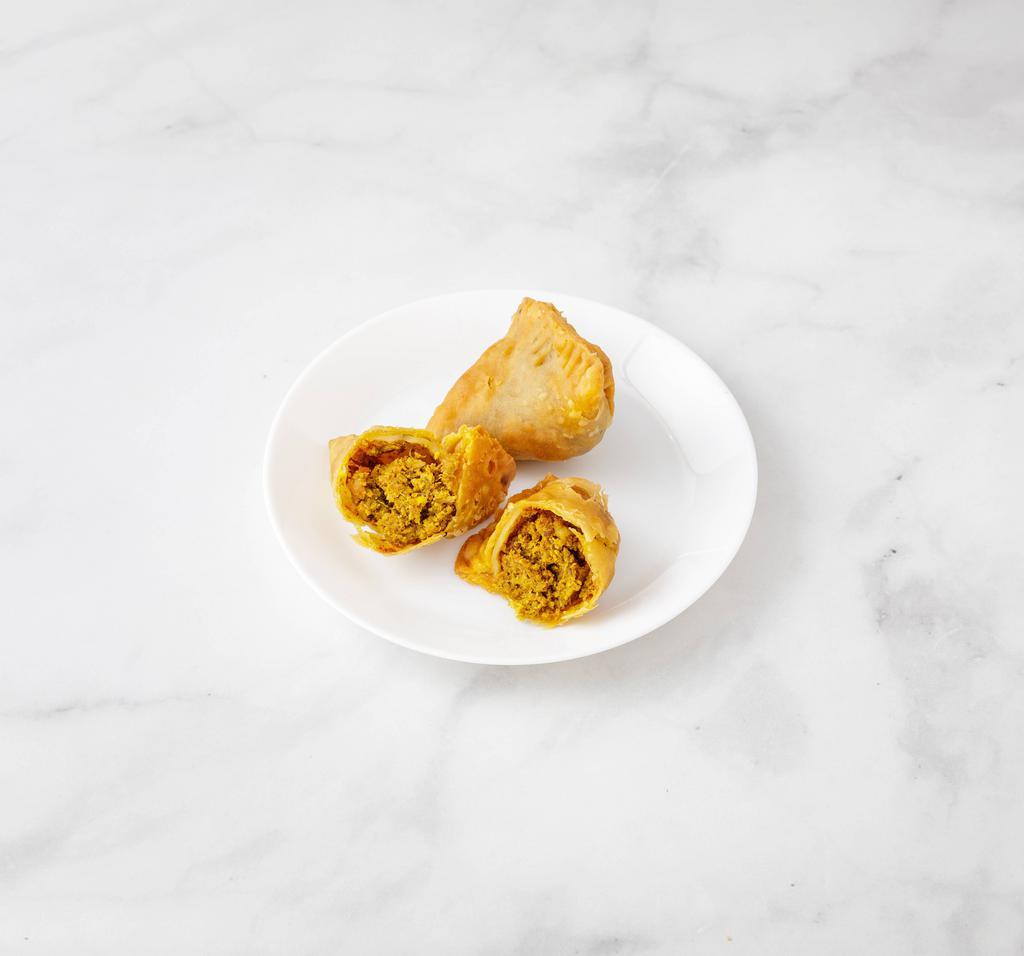 Meat Samosa · 2 pieces. Crispy turnover filled with seasoned minced lamb and green peas.