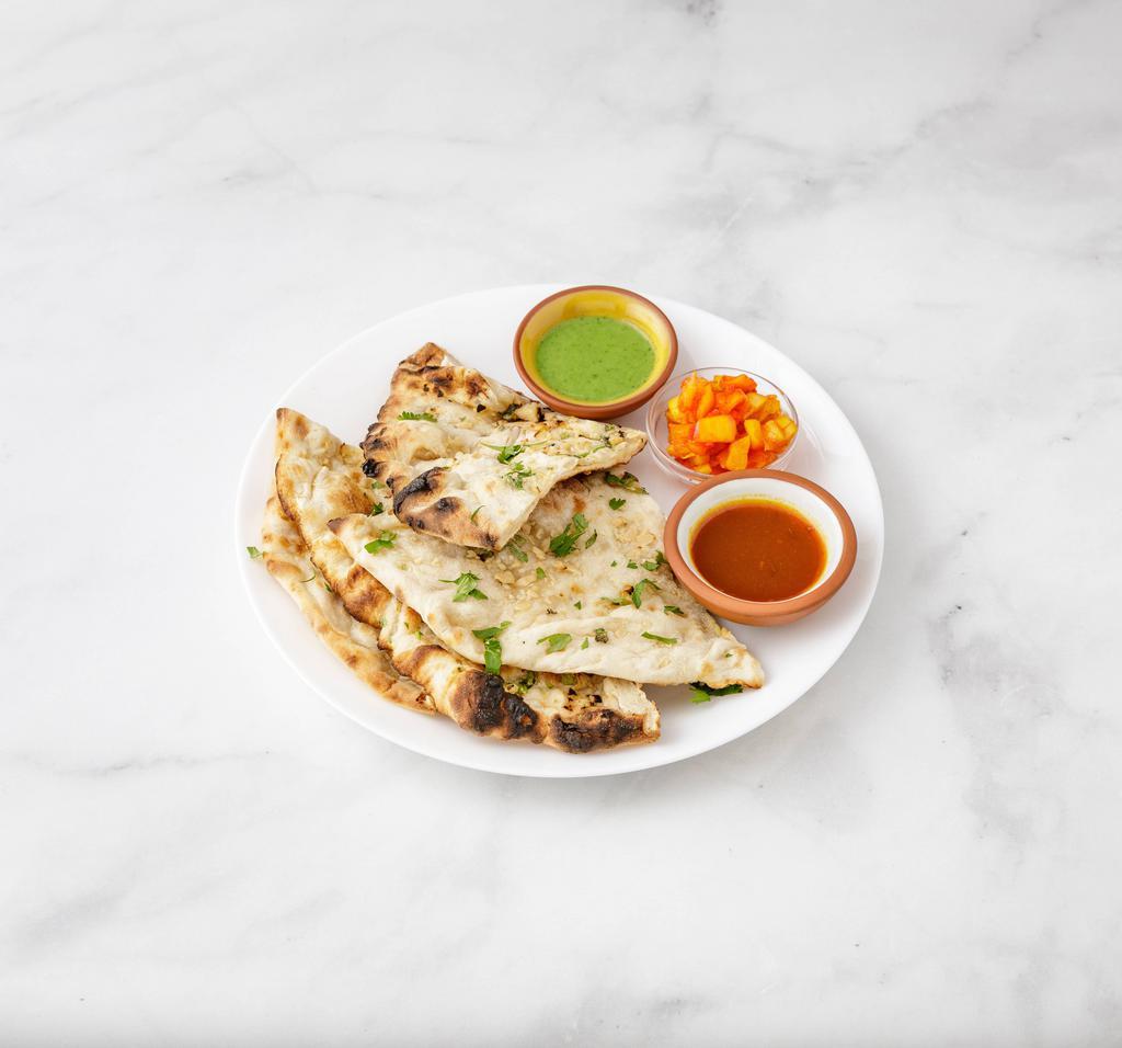 Garlic Naan · Freshly baked bread topped with fresh garlic and herbs.
