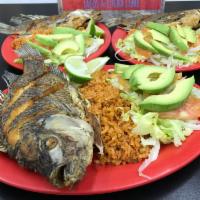 Mojarra Frita // Fried Whole Fish · Mojarra Frita con Arroz, Aguacate y Ensalada. 
A Whole Tilapia (About 1 Lb. ) Deep Fried, wi...