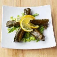 Stuffed Grape Leaves · Grape leaves stuffed with seasoned rice chilled and served with a side of homemade yogurt di...
