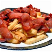 Salchipapas · French fries with fried hot dog sausages.