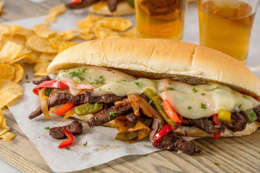 Philly Steak Sandwich · The secrets of a great cheese steak are the quality of the ingredients and the thinness of the ... peppers and onions and cheese slices inside a hero roll.