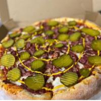 Pastrami Pizza Medium · Sauce, mozzarella cheese, our famous flavorful pastrami, topped with dill pickles and a must...