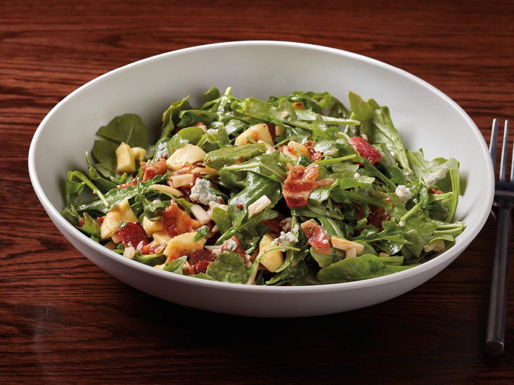 Smoked Bacon Arugula Salad · Baby arugula, toasted slivered almonds, Gorgonzola cheese, oven-dried apples & smoked bacon served with housemade honey-sherry vinaigrette.