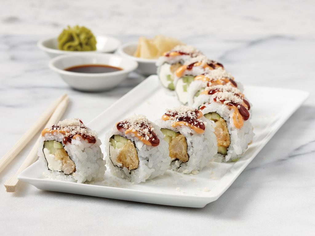Godzilla Roll · Sushi rice, nori, roasted sesame seeds, tempura shrimp, cream cheese, cucumber, sushi sauce, spicy sauce, topped with tempura crunch, soy sauce, ginger and wasabi. 8 pieces.