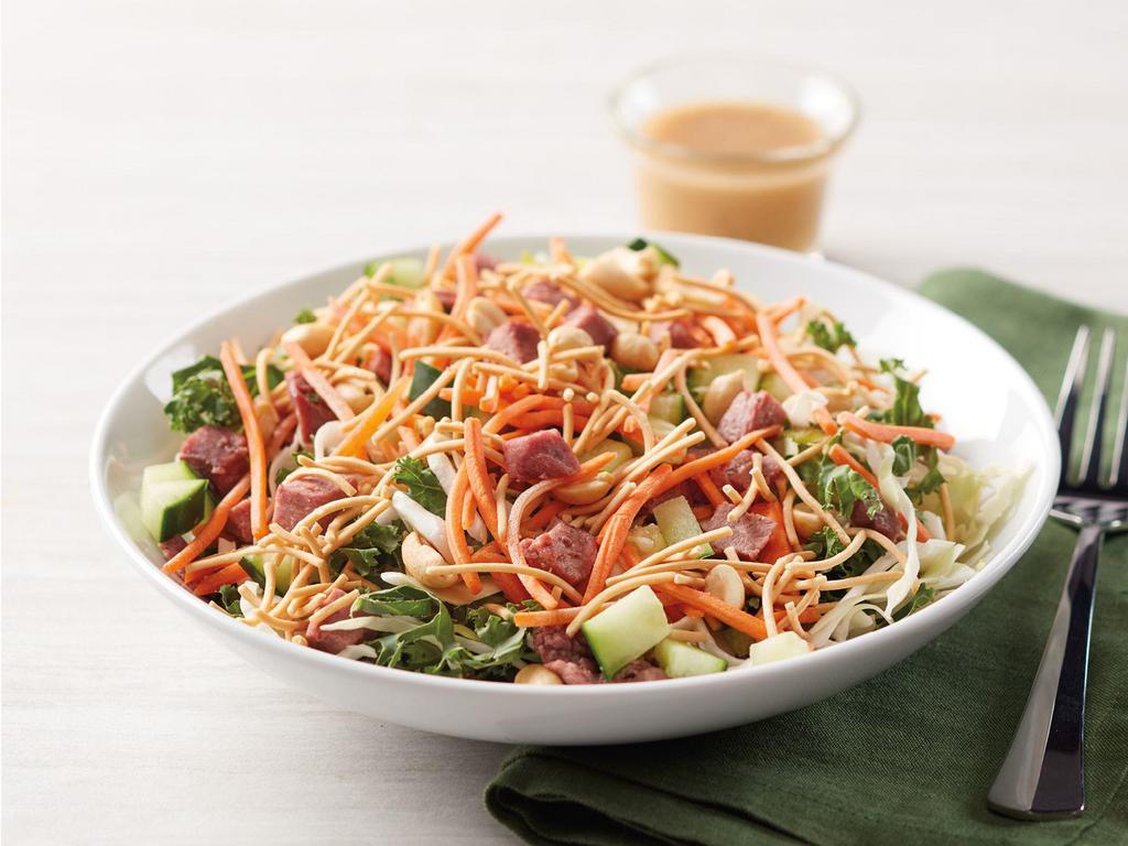 Dilusso Asian Noodle Salad · Kale and green cabbage topped with diced beef, cucumbers, carrots, crispy rice noodles, and peanuts. Packaged with Asian Sesame Dressing.